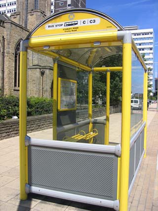 An enclosed bus shelter with seating provision and good use of colour contrast