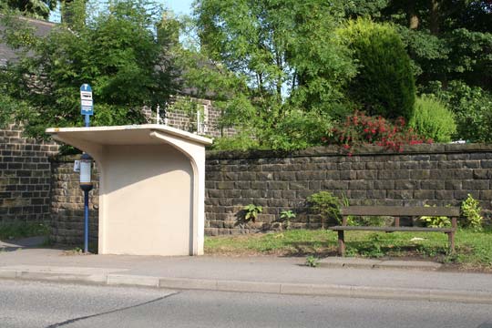 A cantilever type bus shelter with seating some distance apart and in the open air