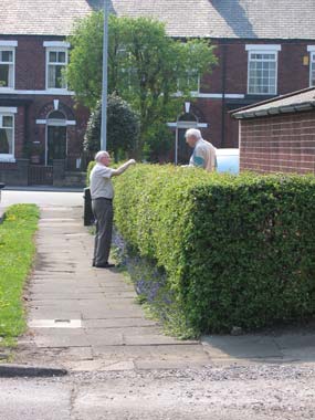 photograph of two men having a conversation from a footpath