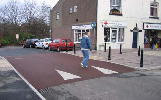 picture of a man walking across an informal crossing??