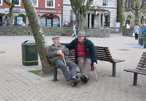 photograph of two men sitting on a bench