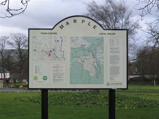 photograph of a town centre and local area sign post with map